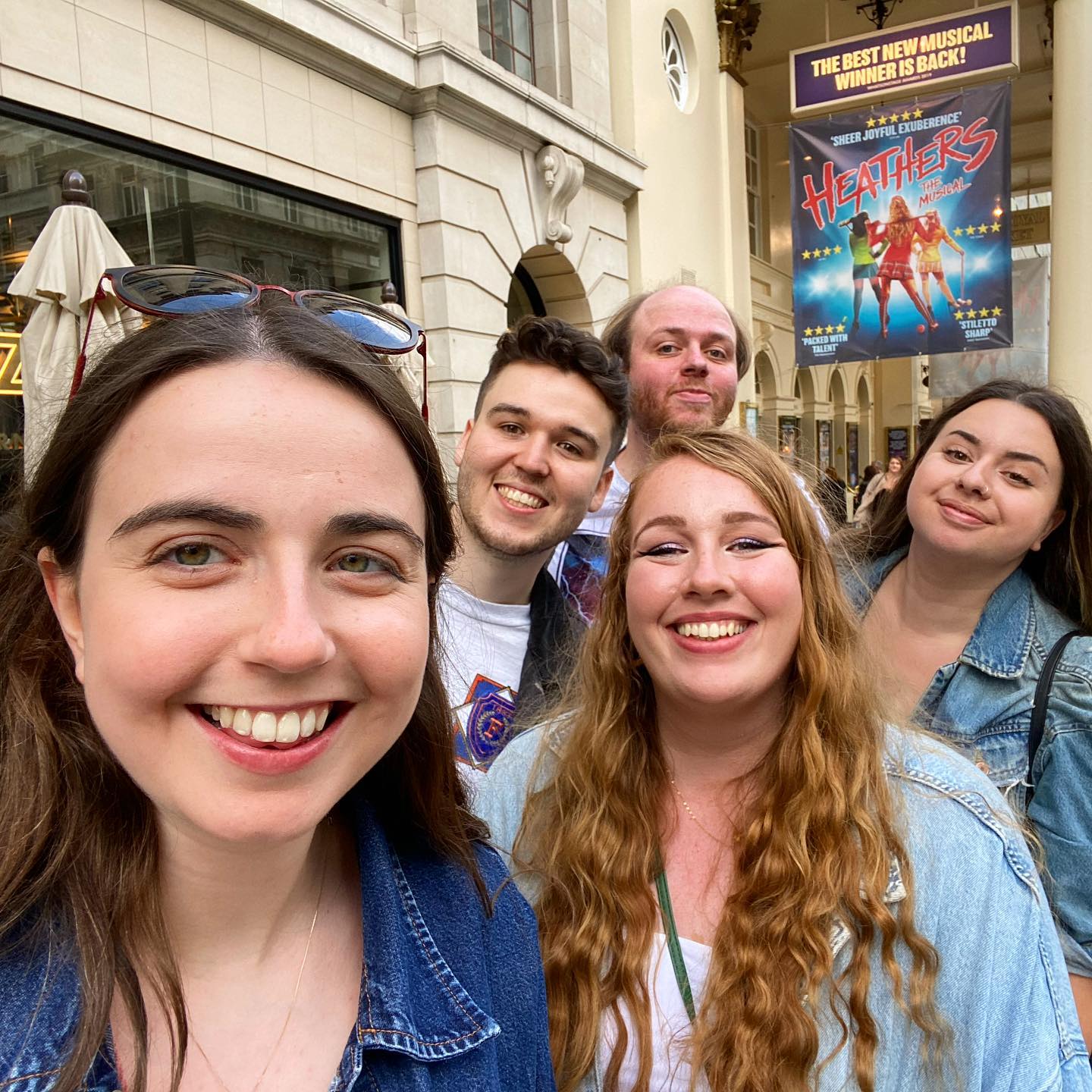 A group of friends outside the Theatre Royal Haymarket during the run of 'Heathers'