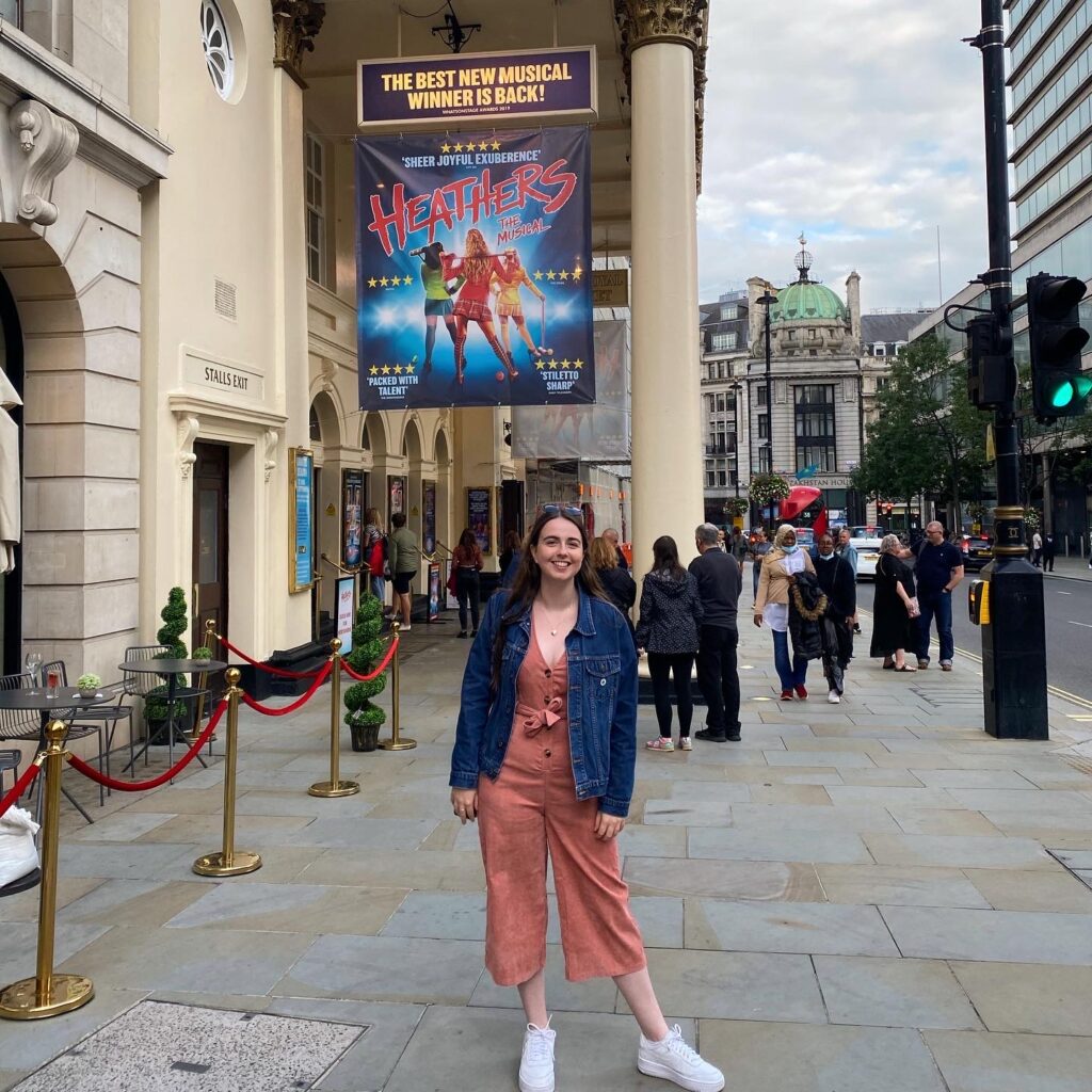 Image of a girl outside the Theatre Royal Haymarket in London.