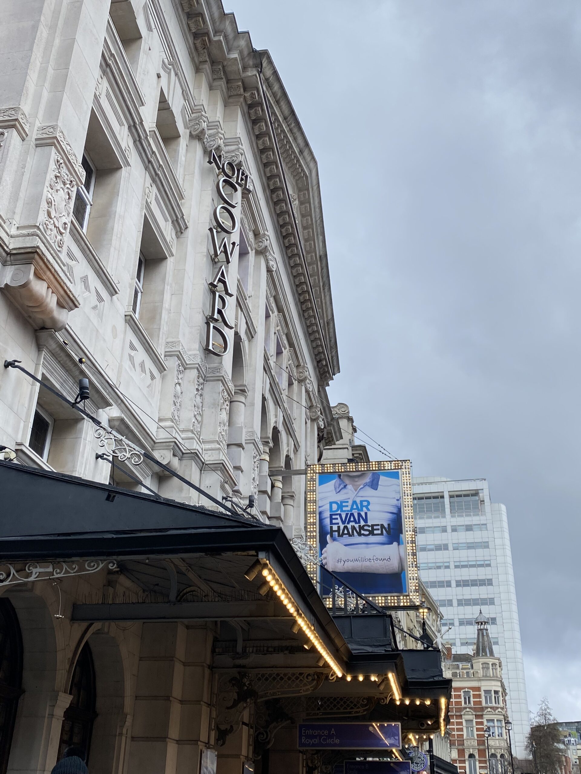 An image of the Noel Coward Theatre with the Dear Evan Poster advertising the show inside.